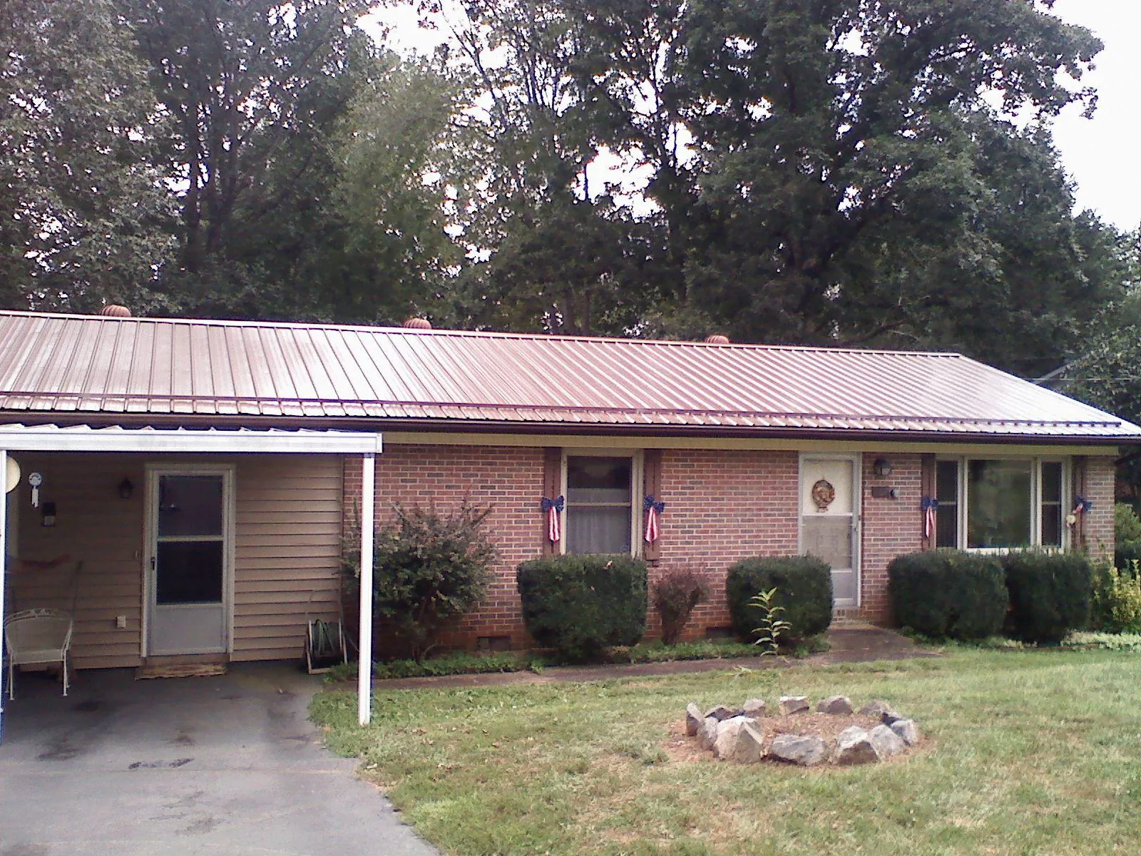 Bronze metal roof and carport on a brick ranch home — Roof Repair work by our crew in Newmanstown